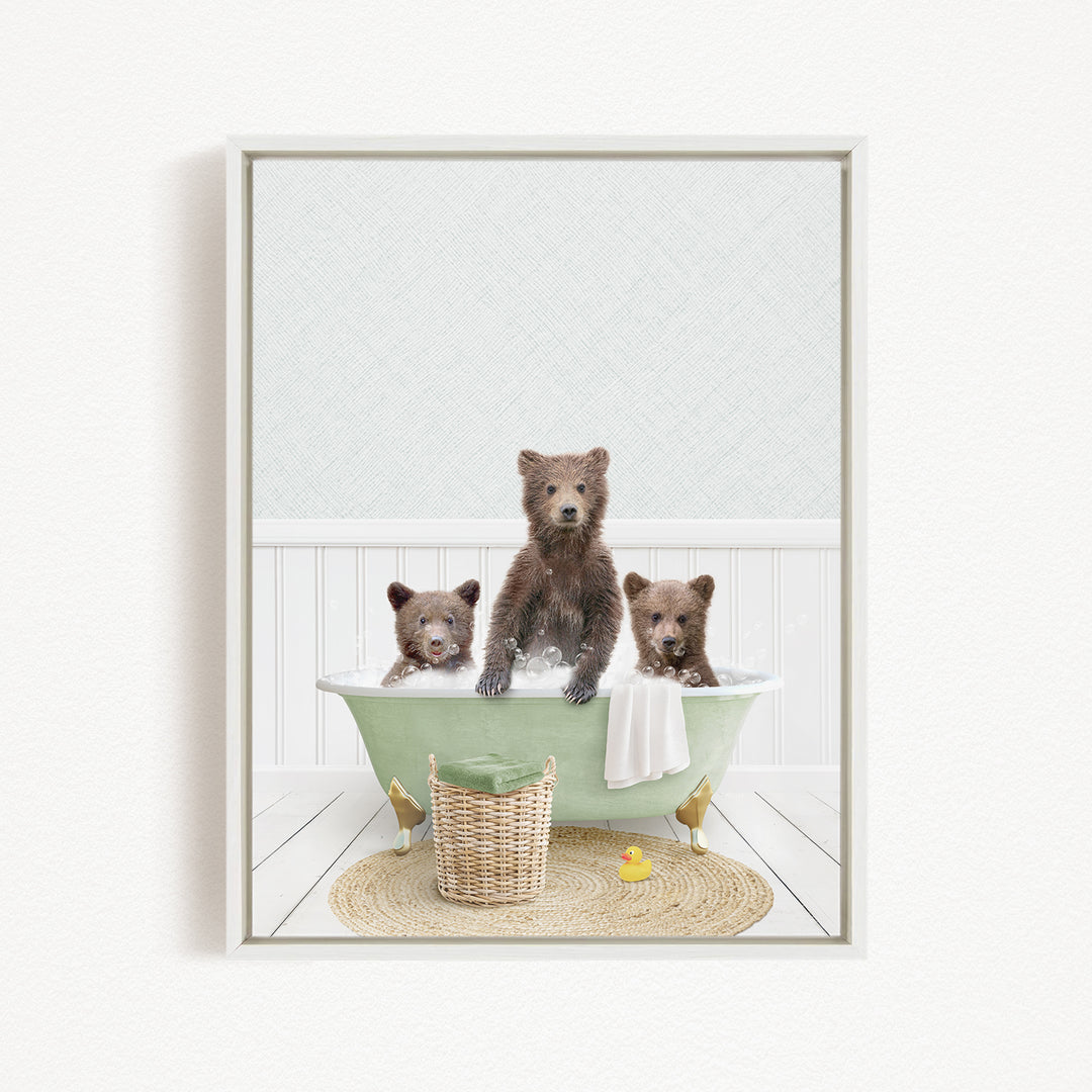 A framed image depicting three adorable brown bears sitting in a green bathtub, with a yellow rubber duck floating in the water.