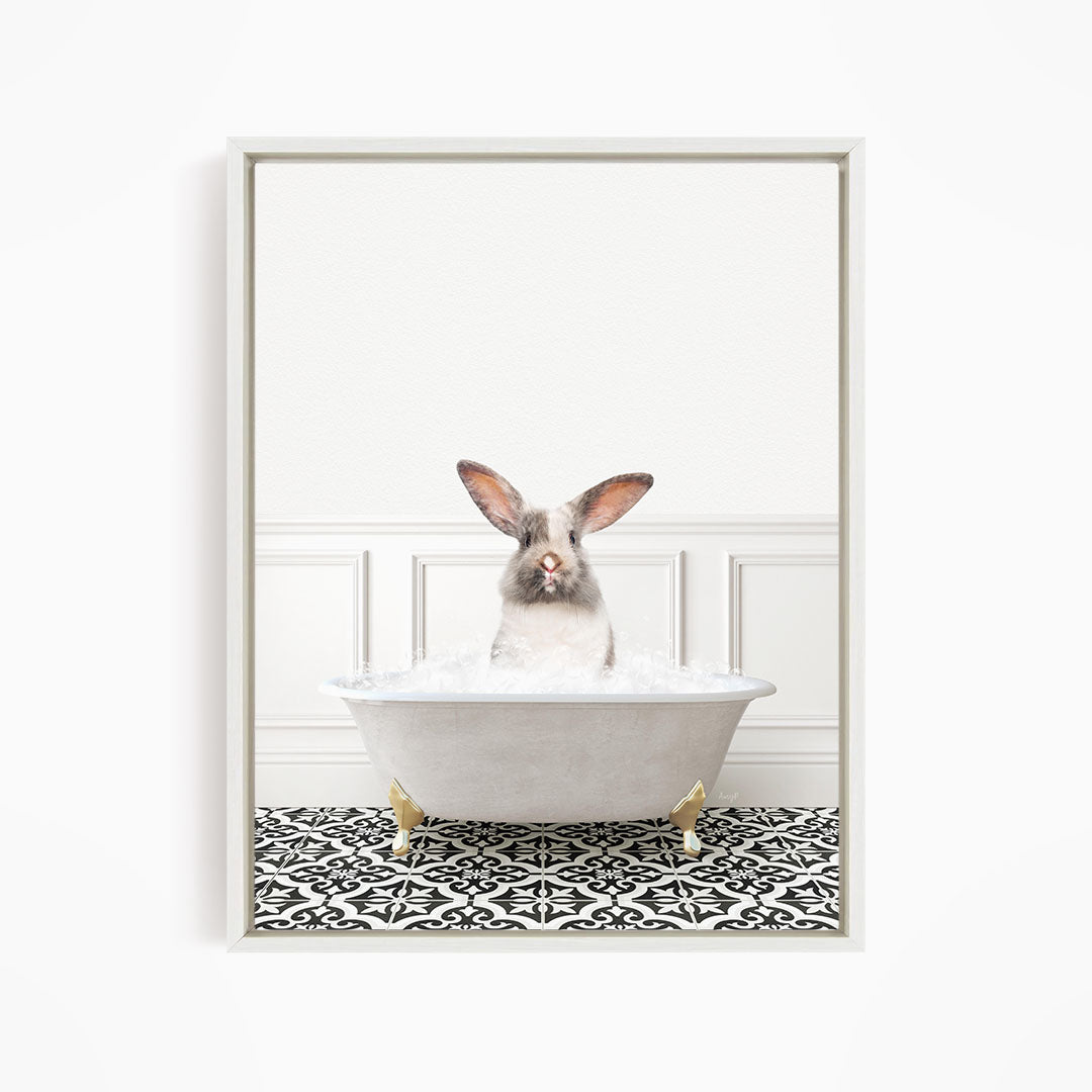 A white rabbit sitting in a white bathtub filled with water, with a black and white patterned floor in the background.