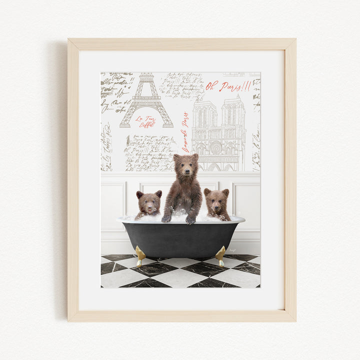 A framed image depicting three bears sitting in a bathtub, with a Paris-themed background featuring the Eiffel Tower and other Parisian landmarks.