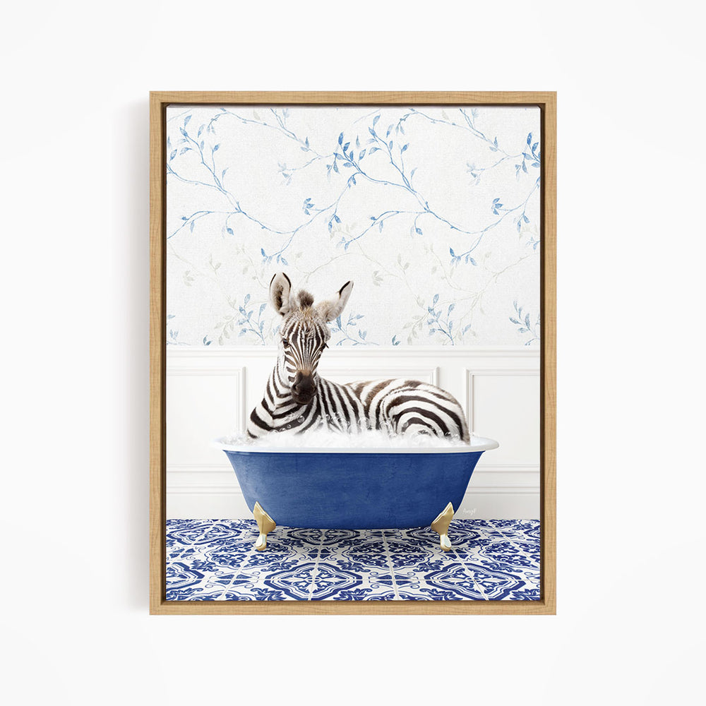 A zebra is sitting in a blue bathtub, surrounded by a patterned tile floor and a floral wallpaper background.
