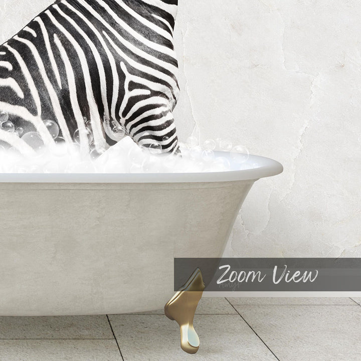 A zebra standing in a bathtub filled with bubbles, with a gold bathtub faucet visible.