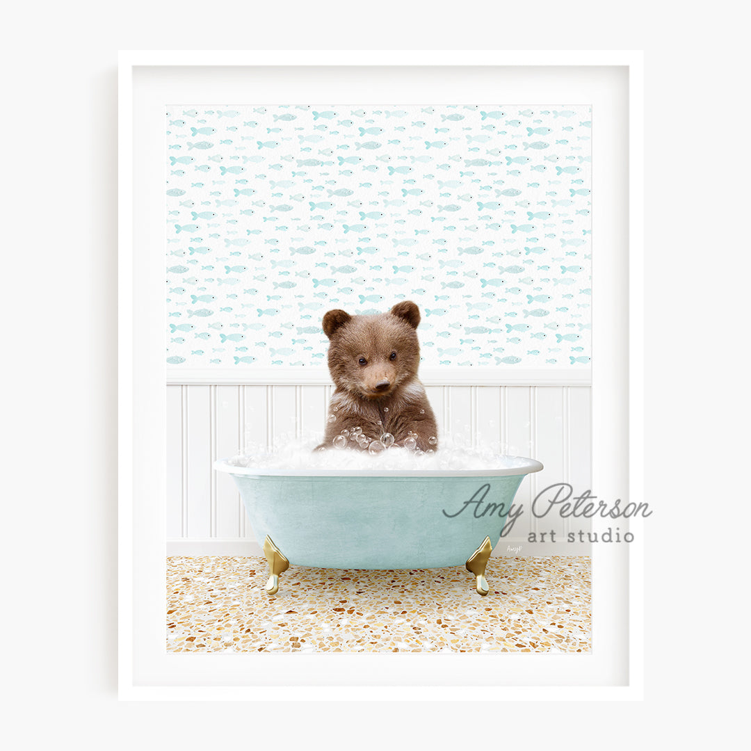 a small teddy bear sitting in a bath tub