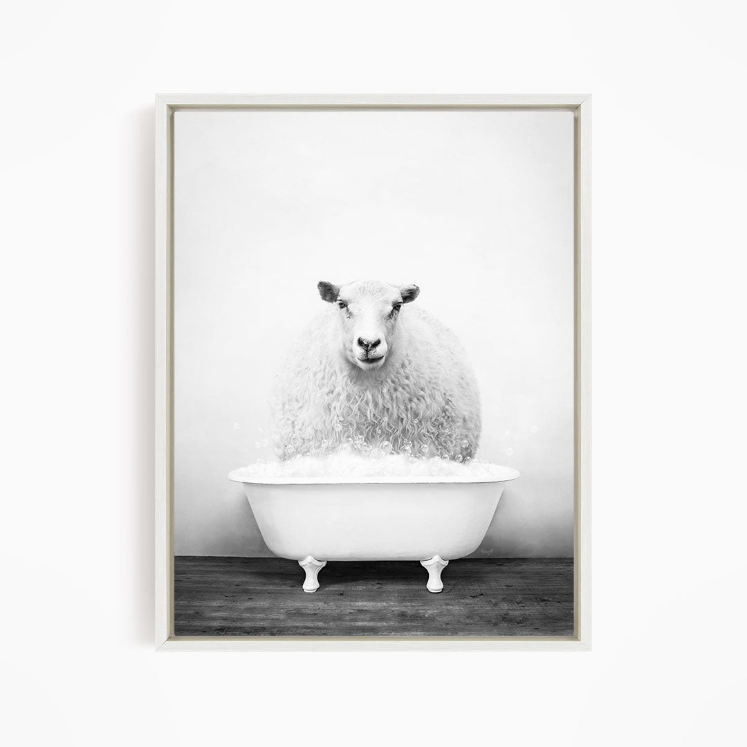 A fluffy white sheep is sitting in a white bathtub filled with bubbles, creating a whimsical and playful scene.