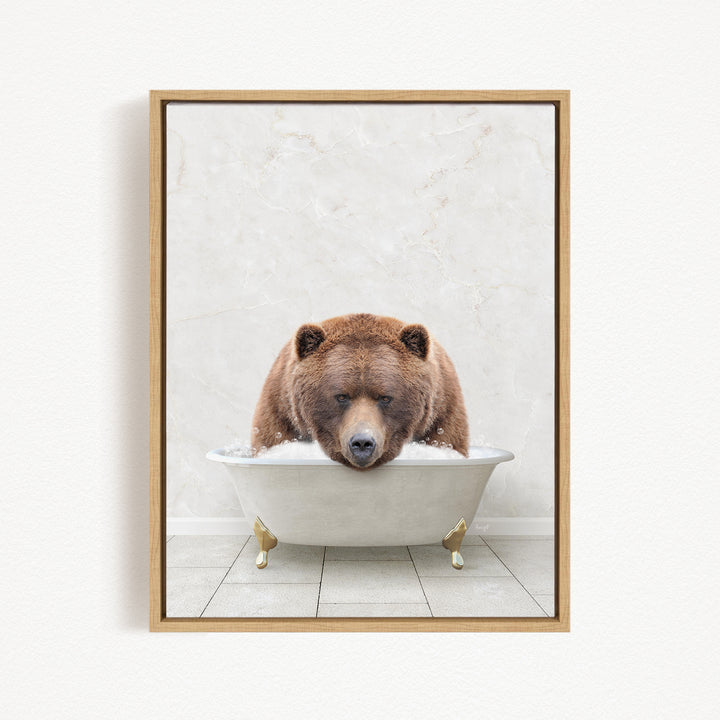 A brown bear is sitting in a white bathtub, appearing to be enjoying a relaxing bath.