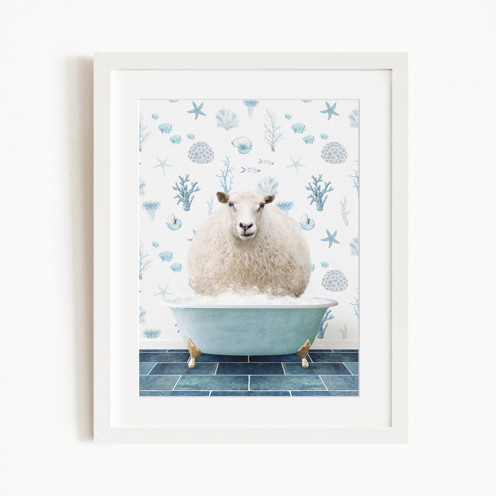 A white sheep is sitting in a blue bathtub, surrounded by a pattern of blue and white seashells and starfish.