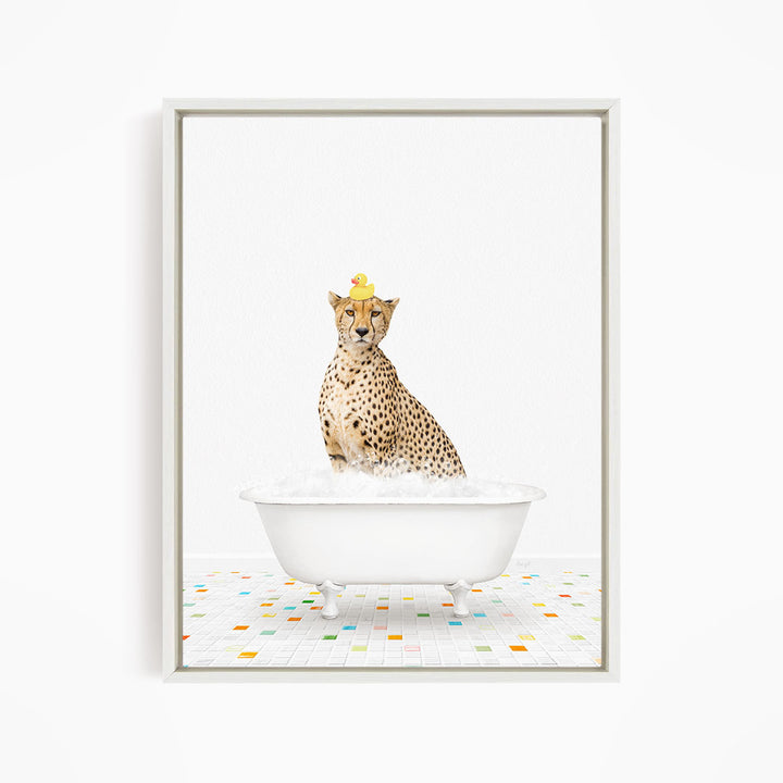 A cheetah sitting in a white bathtub filled with bubbles, with a rubber duck perched on its head.