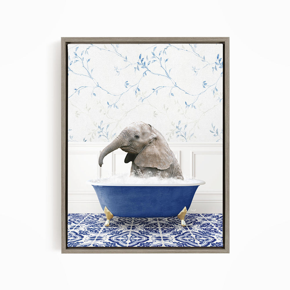 A baby elephant sitting in a blue bathtub filled with water, surrounded by a blue and white patterned rug.