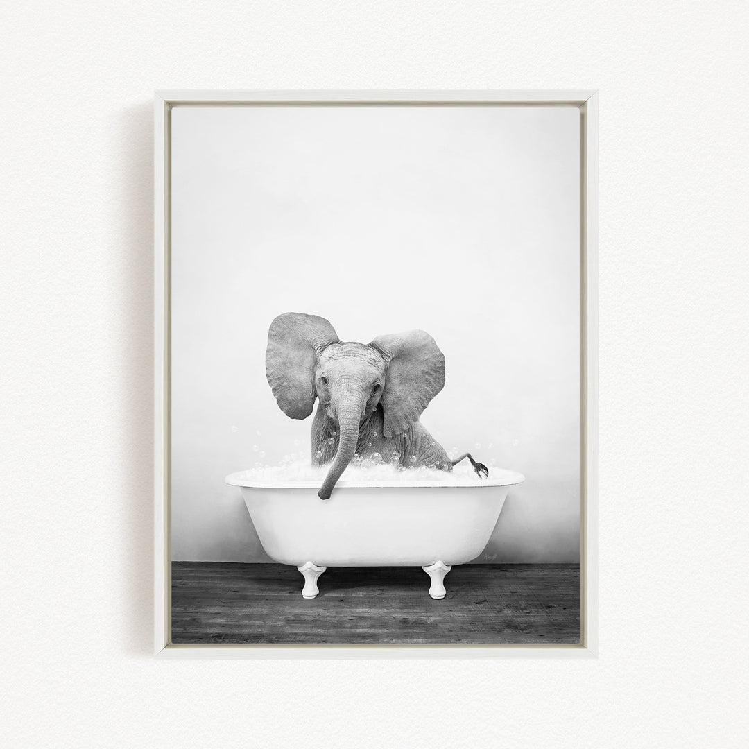A baby elephant sitting in a white bathtub filled with water, creating a playful and whimsical scene.