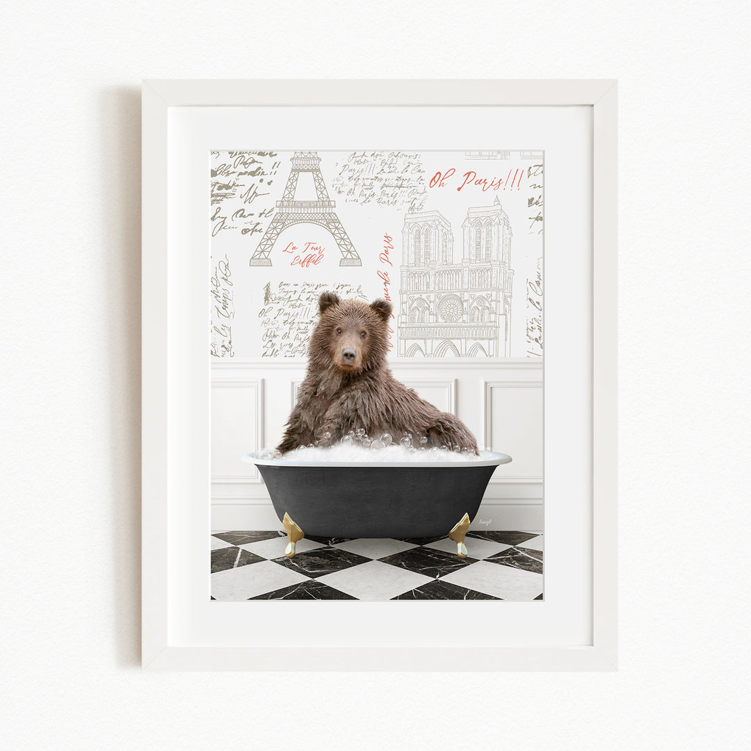A brown bear sitting in a bathtub filled with bubbles, with a Paris-themed background behind it.