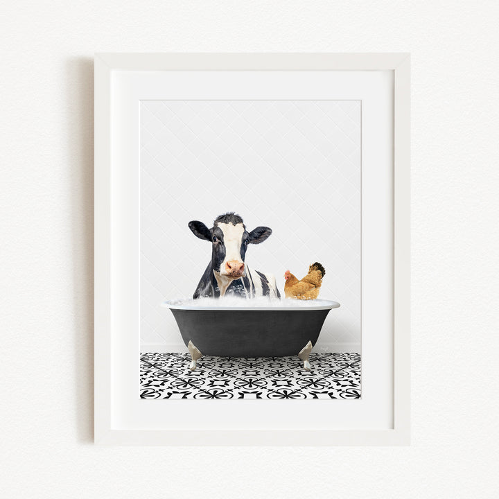 A black and white cow is sitting in a bathtub filled with water, accompanied by a chicken.
