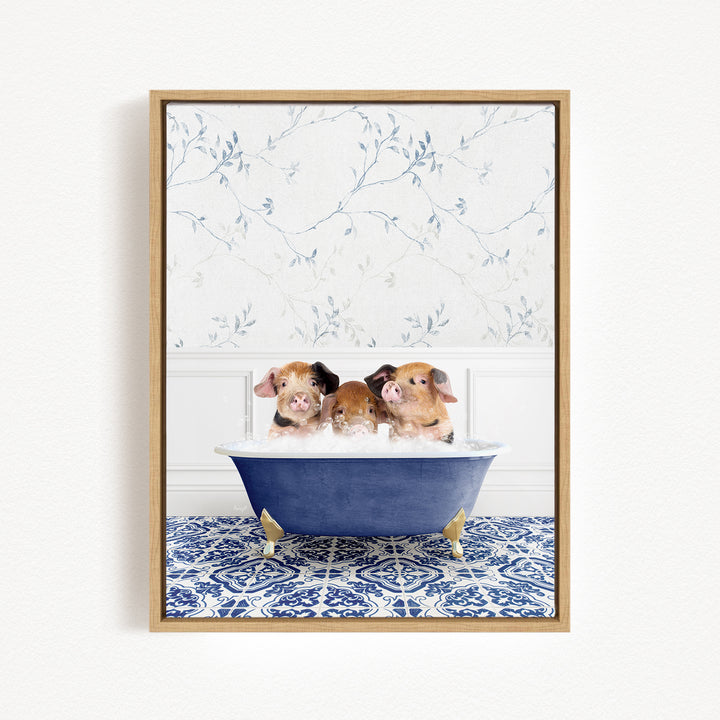 Three adorable pigs sitting in a blue bathtub, surrounded by a floral patterned wall.
