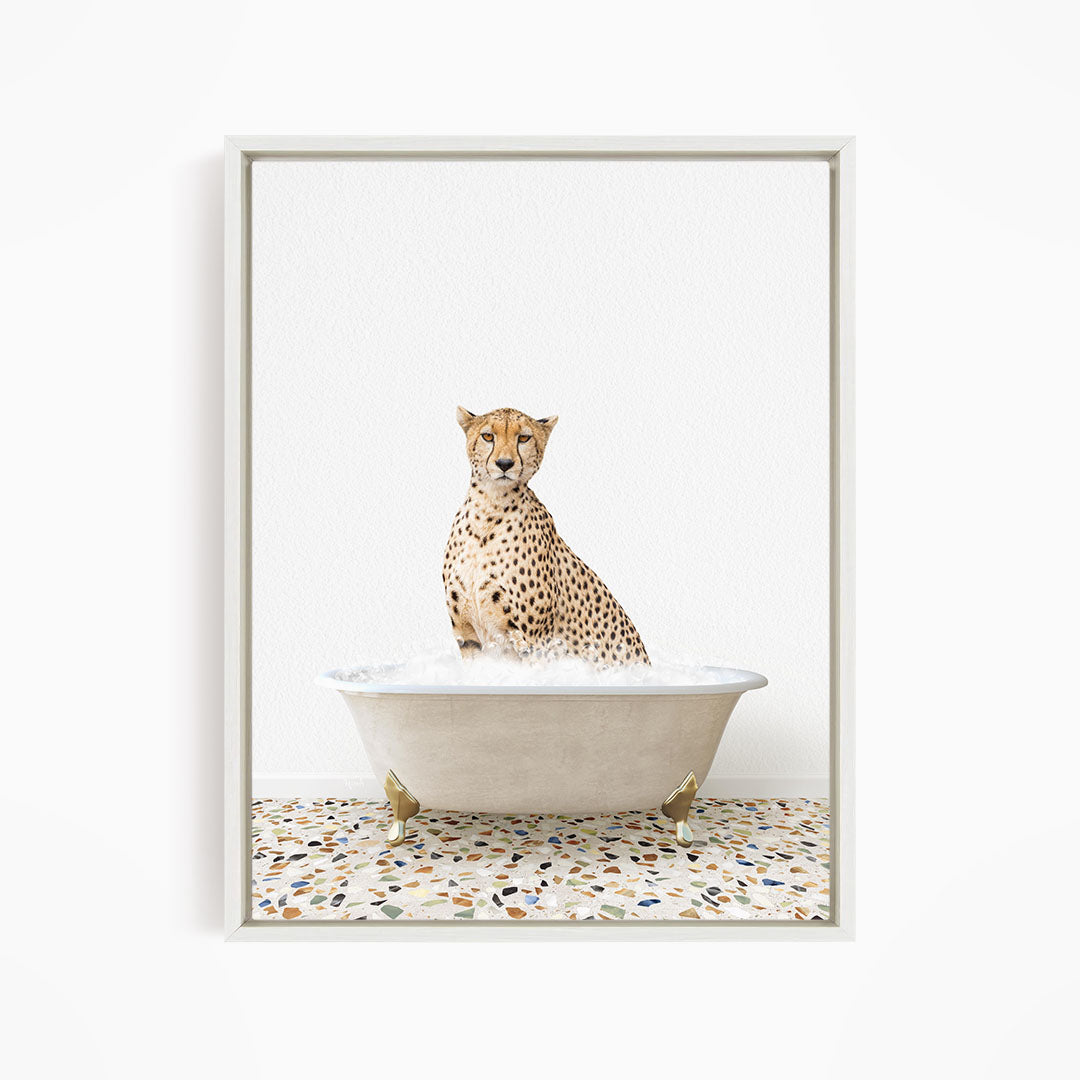 A cheetah sitting in a white bathtub filled with water, with a speckled floor in the background.