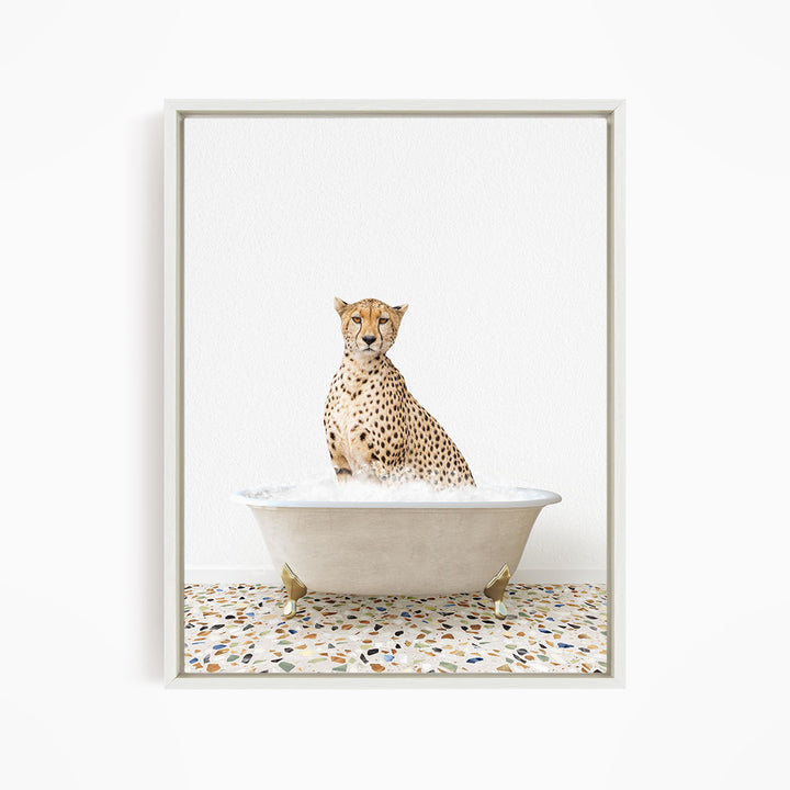A cheetah sitting in a white bathtub filled with water, with a speckled floor in the background.