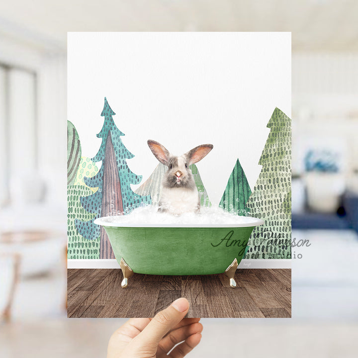 a person holding up a card with a picture of a bunny in a bathtub