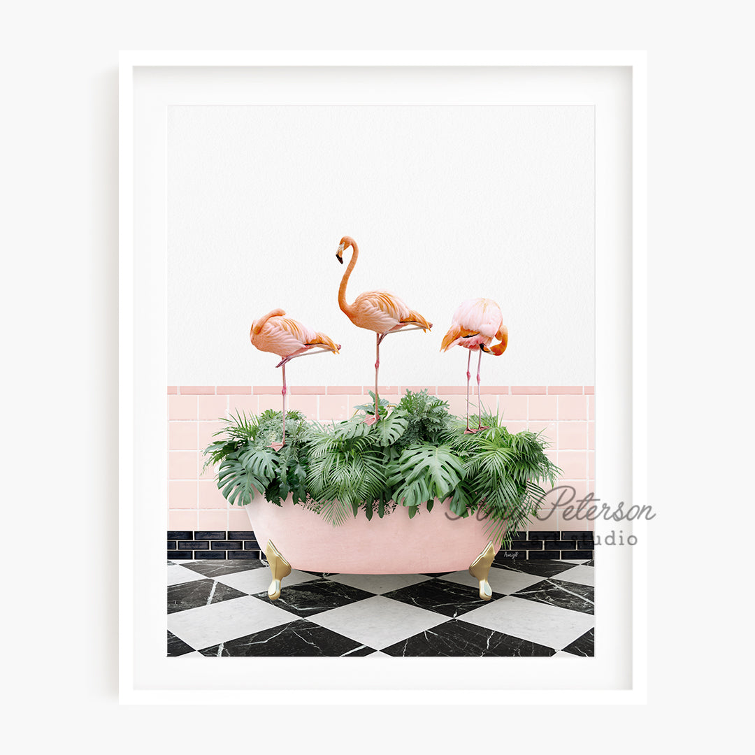 a pink bathtub with three flamingos in it