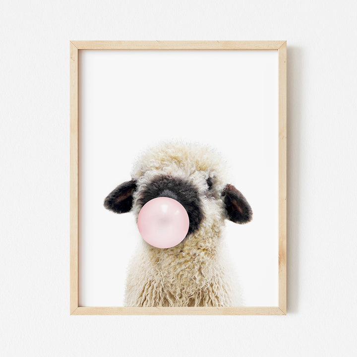 a sheep with a bubble gum in its mouth