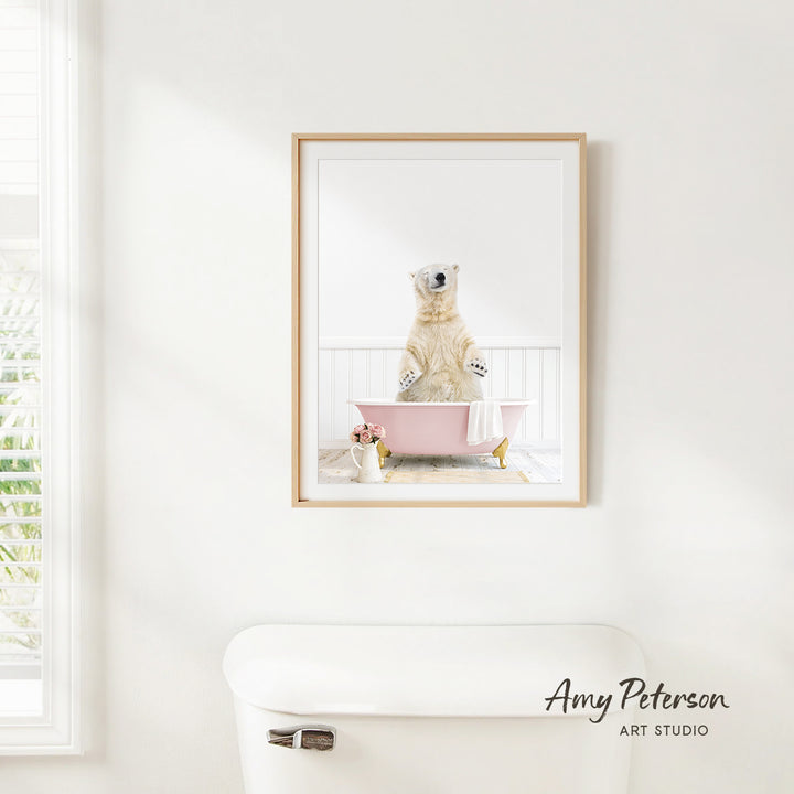 A polar bear sitting in a pink bathtub, surrounded by flowers, is the focus of the image.