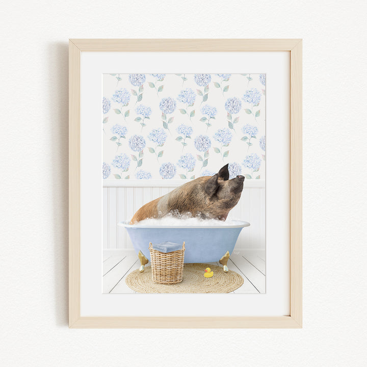 A brown dog is sitting in a blue bathtub filled with bubbles, surrounded by a white floral pattern on the wall behind it.