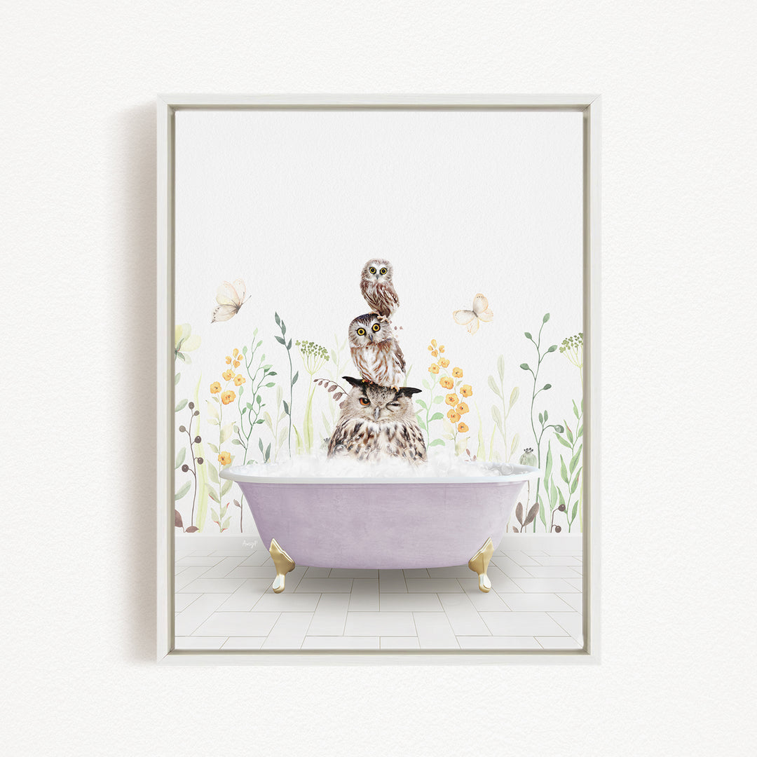 A framed illustration depicting a cat sitting in a bathtub filled with bubbles, surrounded by flowers and butterflies.