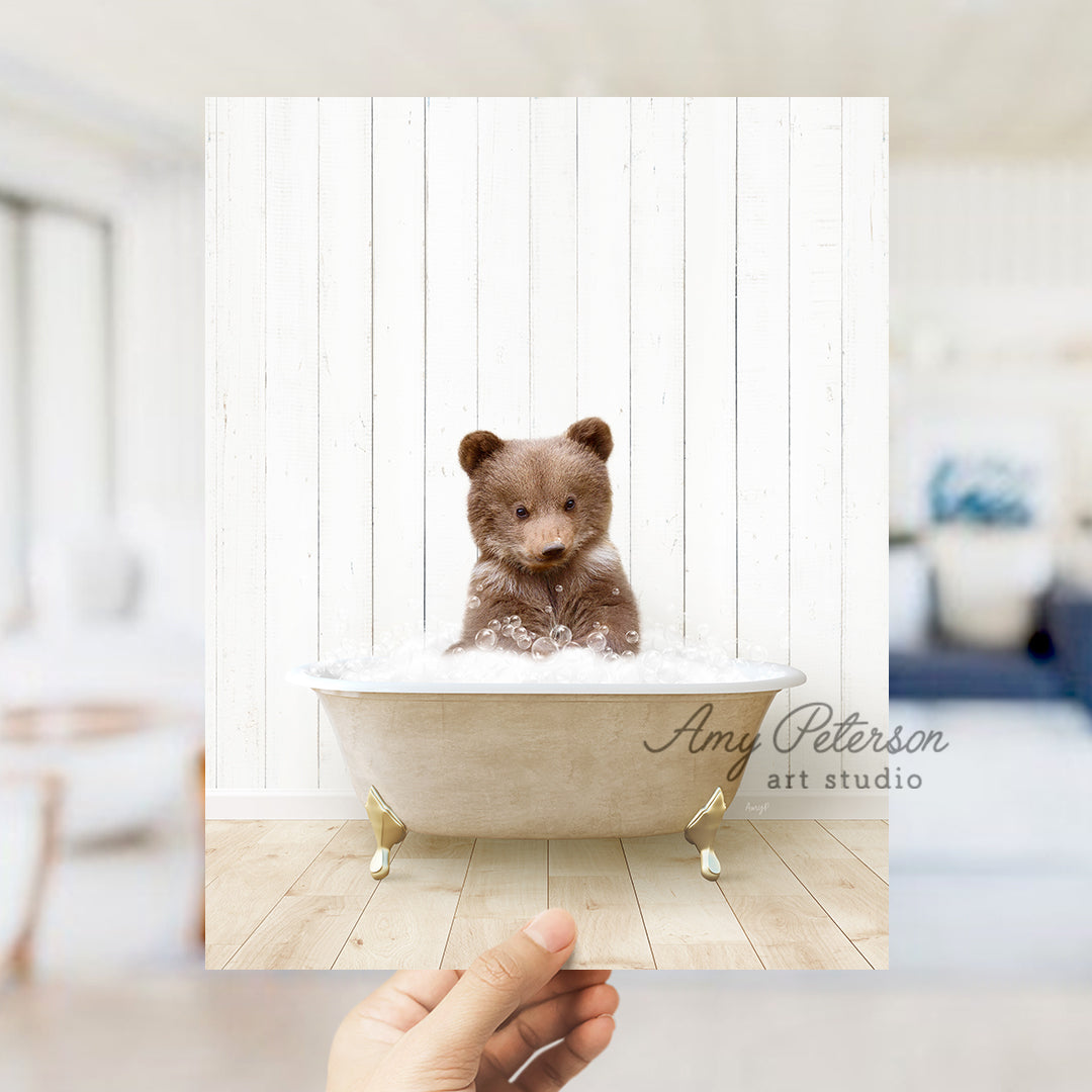 a small teddy bear sitting in a bath tub