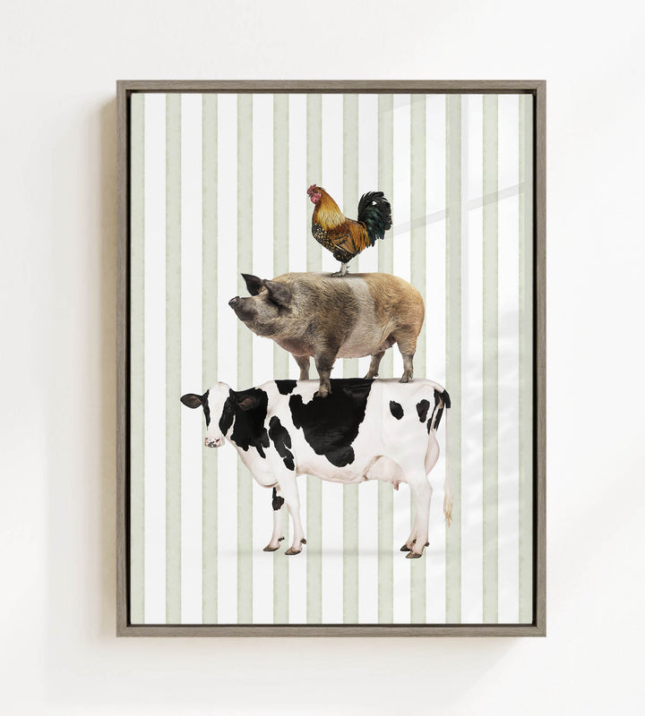 A framed image depicting a cow, a rooster, and a pig standing on top of each other.