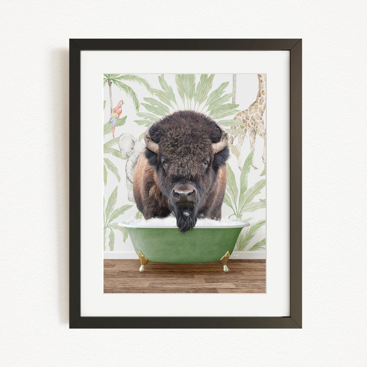 A framed image depicting a bison standing in a green bathtub, surrounded by tropical foliage.