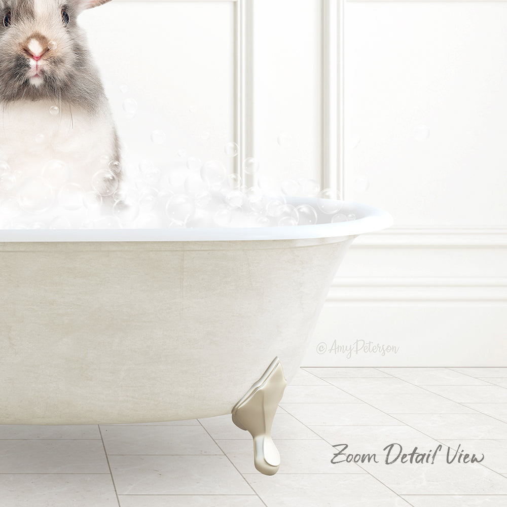 A small rabbit sitting in a white bathtub filled with bubbles, with a white wall and tiled floor in the background.