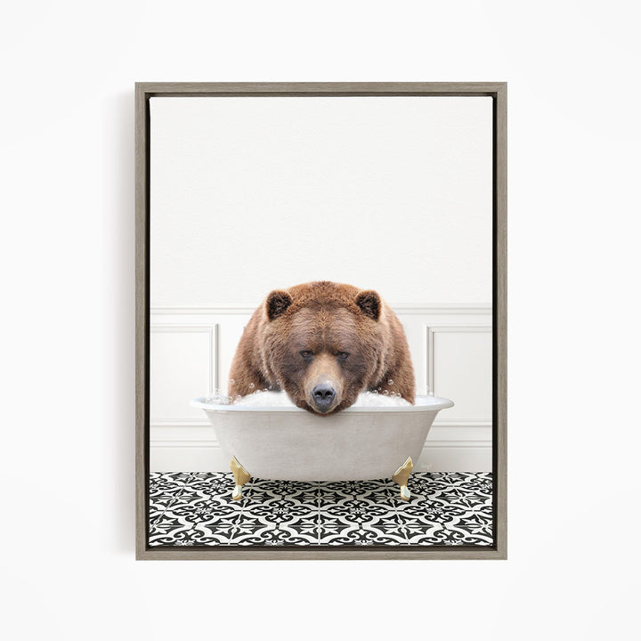 A brown bear is sitting in a white bathtub filled with water, appearing to be enjoying a relaxing bath.