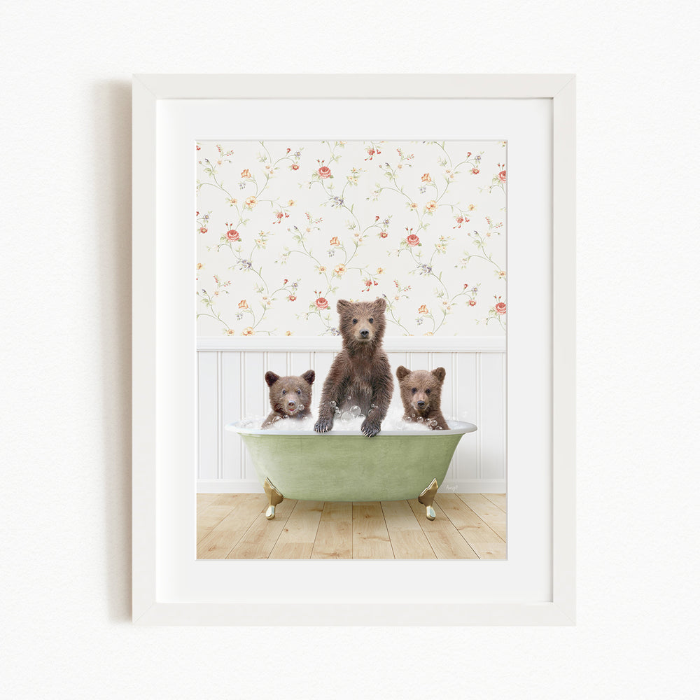 Three adorable brown bears sitting in a green bathtub, with a floral wallpaper in the background.