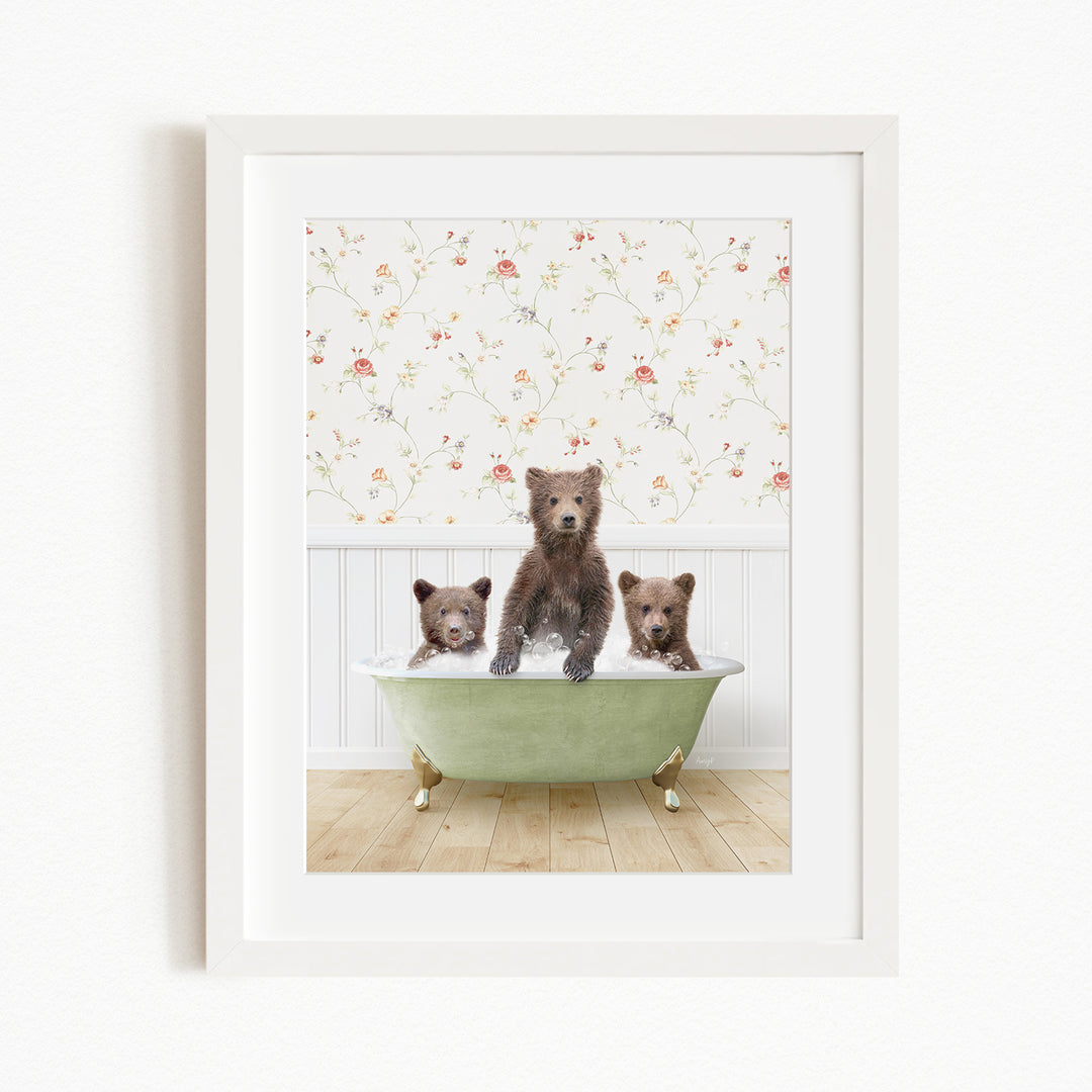 Three adorable brown bears sitting in a green bathtub, with a floral wallpaper in the background.