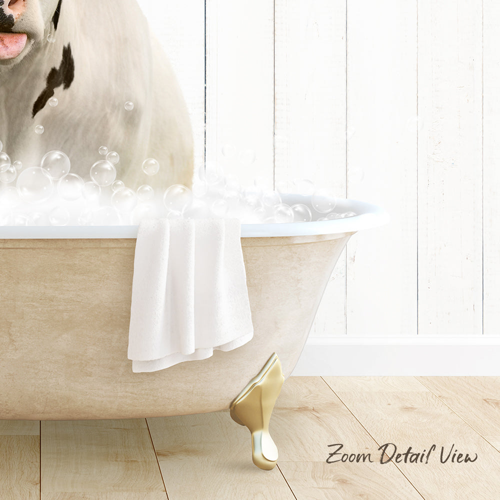 A dog is sitting in a bathtub filled with bubbles, with a towel hanging on the side and a wooden floor visible in the background.