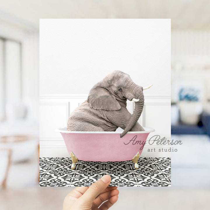 an elephant sitting in a pink bath tub