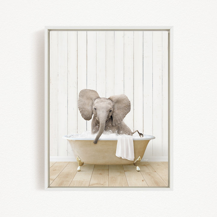 A baby elephant sitting in a bathtub filled with water, surrounded by a white wooden wall.