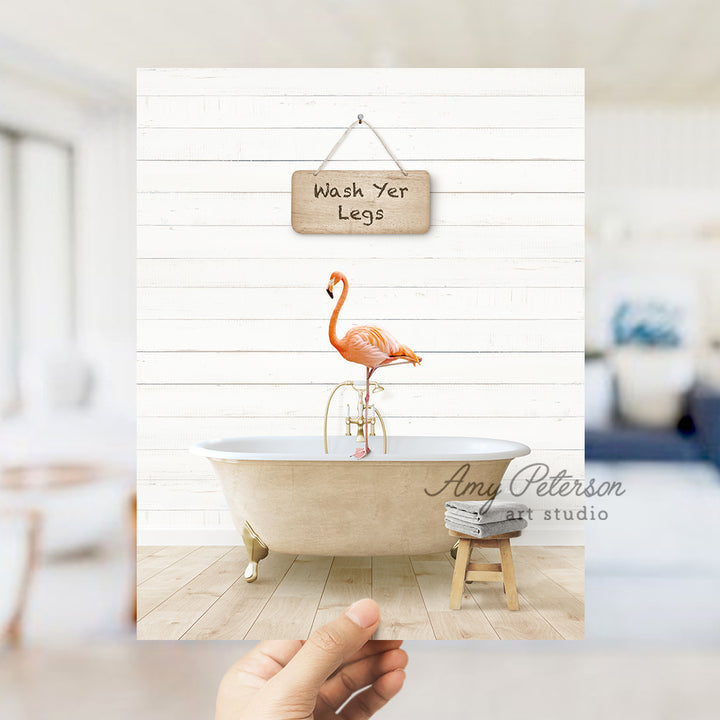 a person holding a card with a flamingo in a bathtub