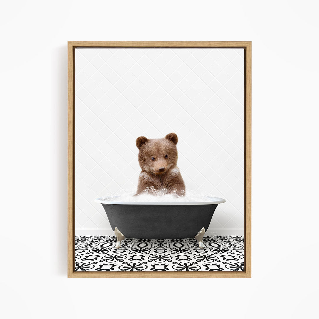 A cute brown bear sitting in a black bathtub filled with water, surrounded by a black and white patterned floor.