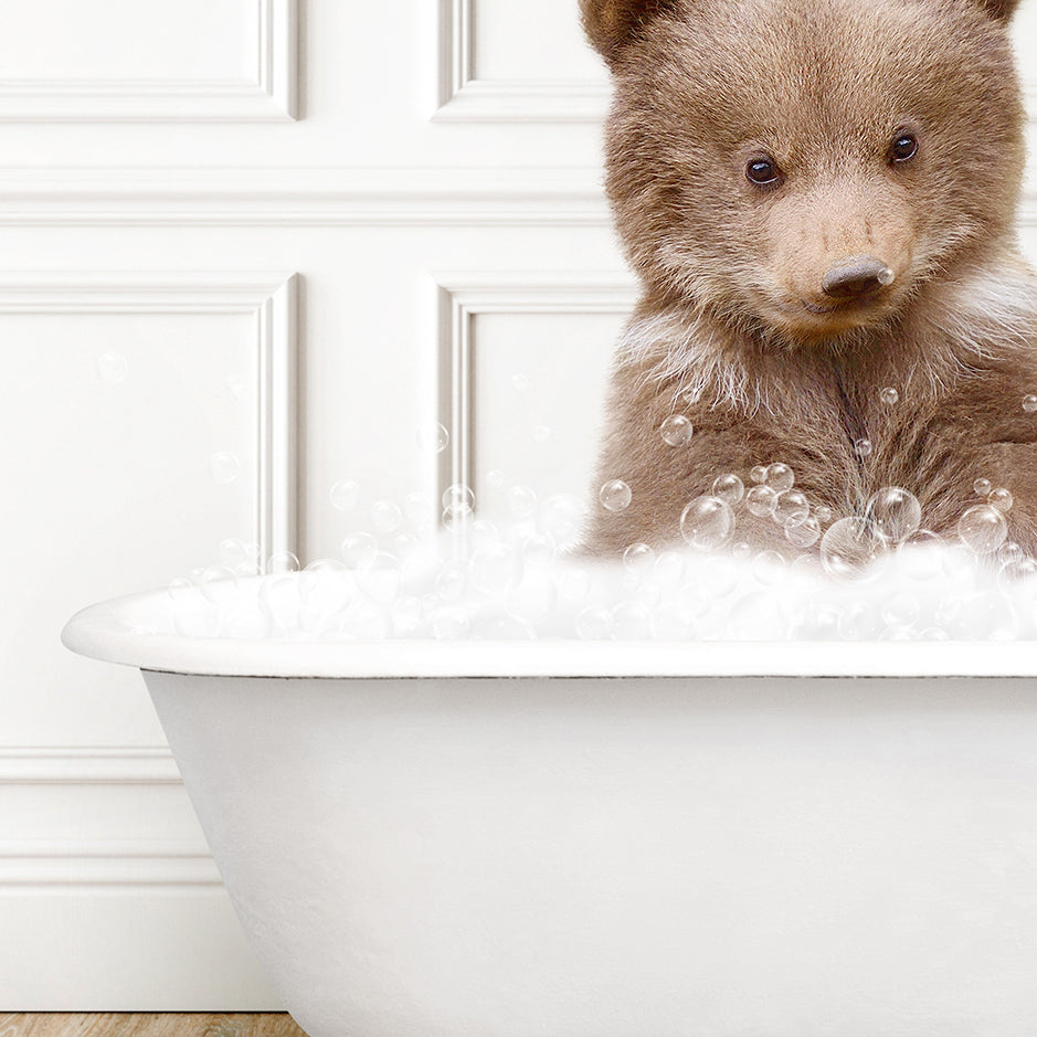 a brown bear sitting in a bath tub filled with bubbles