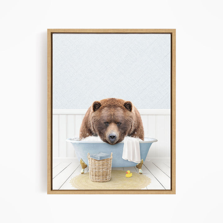 A brown bear is sitting in a blue bathtub filled with water, surrounded by rubber ducks and a basket.