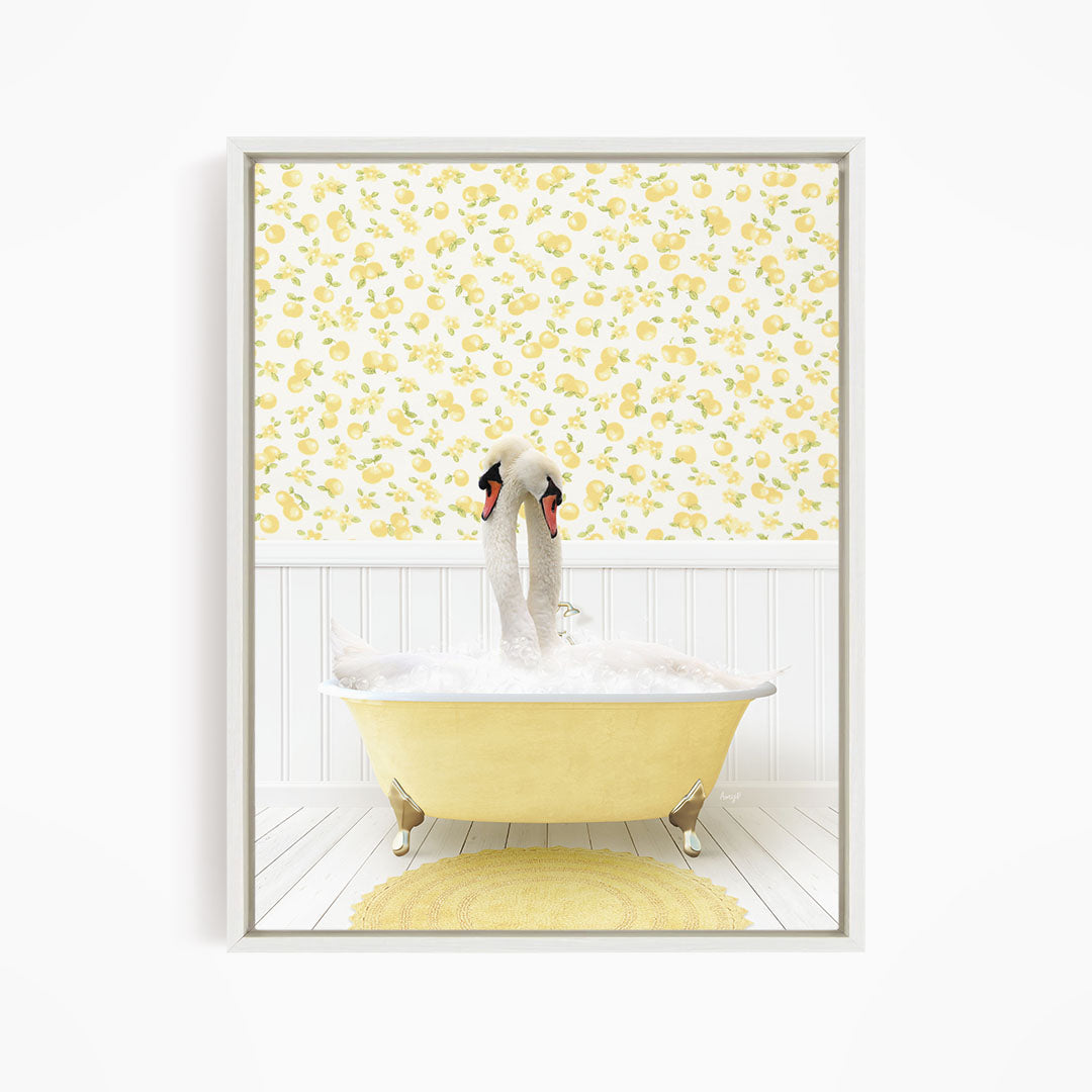 A white swan is sitting in a yellow bathtub filled with bubbles, with a yellow and white floral wallpaper behind it.