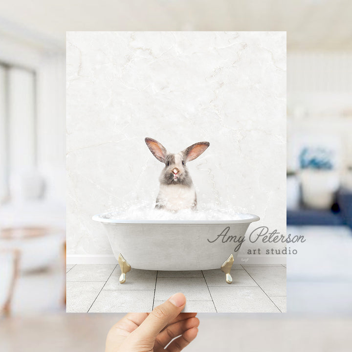 a person holding up a photo of a rabbit in a bathtub