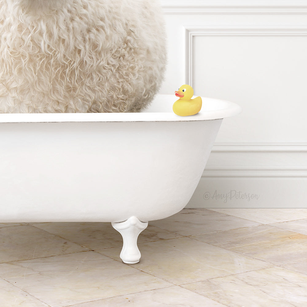 A fluffy white sheep sits in a white bathtub, with a yellow rubber duck perched on the edge of the tub.