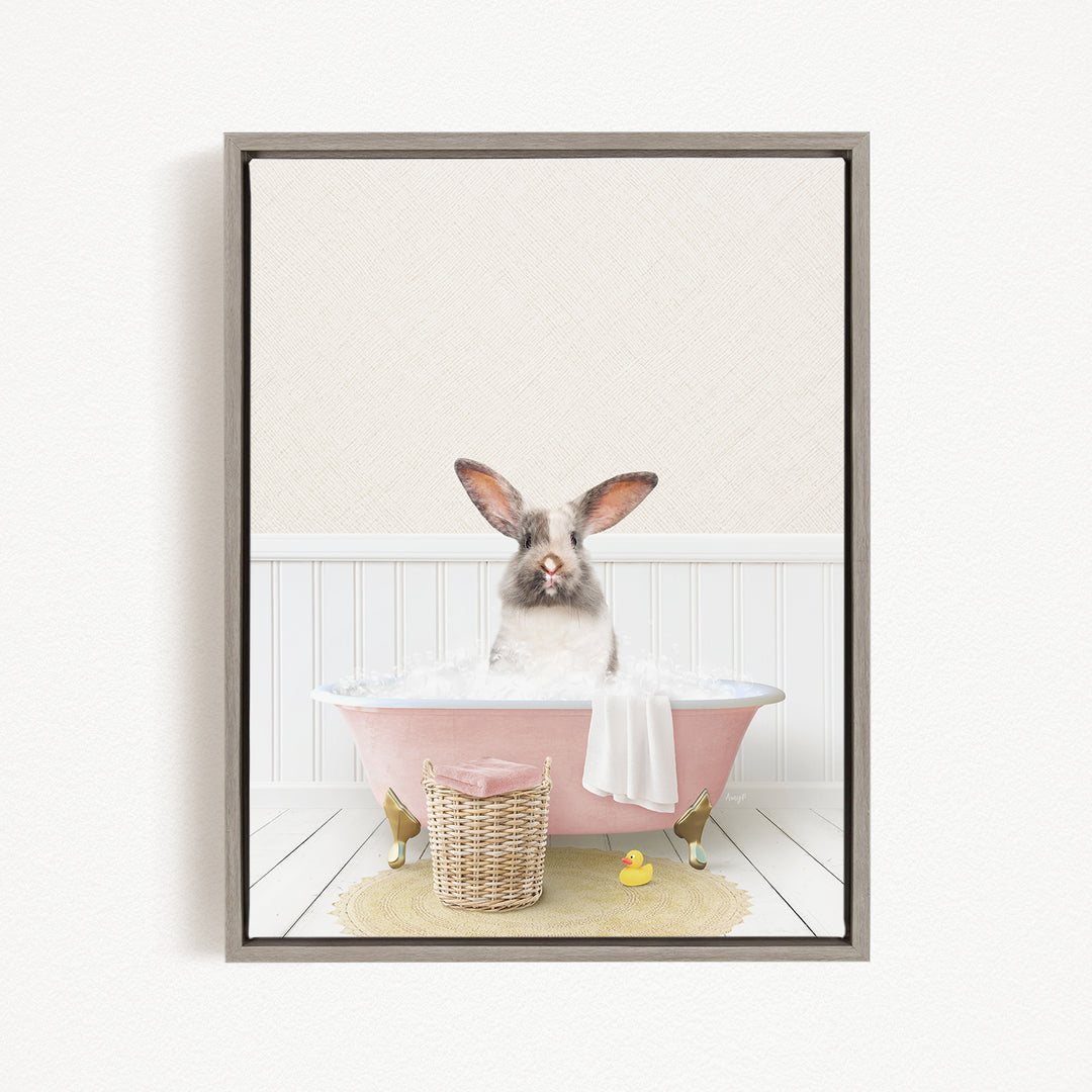 A white rabbit sitting in a pink bathtub filled with water, surrounded by a yellow rubber duck and a wicker basket.