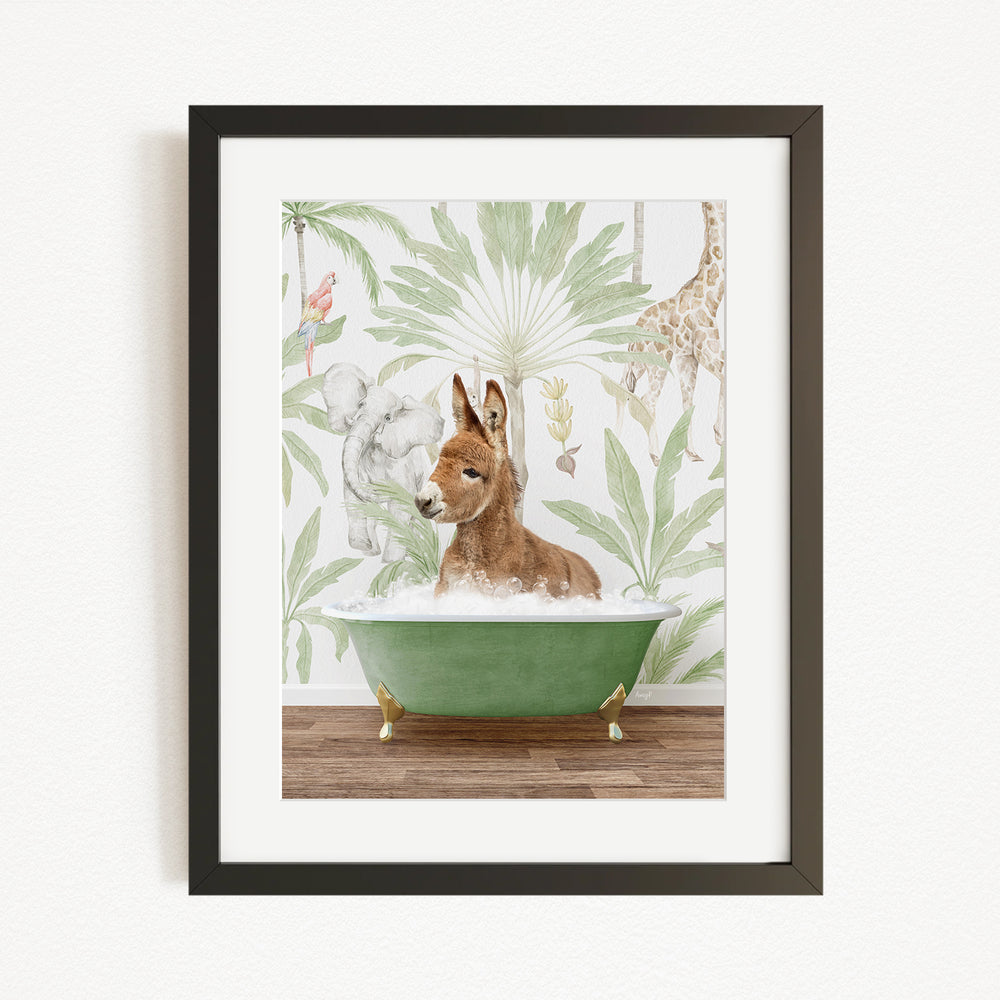 A framed print depicting a donkey sitting in a green bathtub, surrounded by a tropical jungle scene with various animals, including a giraffe and a kangaroo.