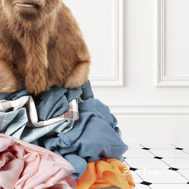 A pile of clothes, including a brown dog sitting on top of the pile, against a white wall.