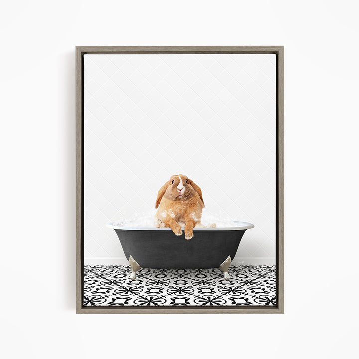 A brown rabbit sitting in a bathtub filled with water, surrounded by a black and white patterned floor.