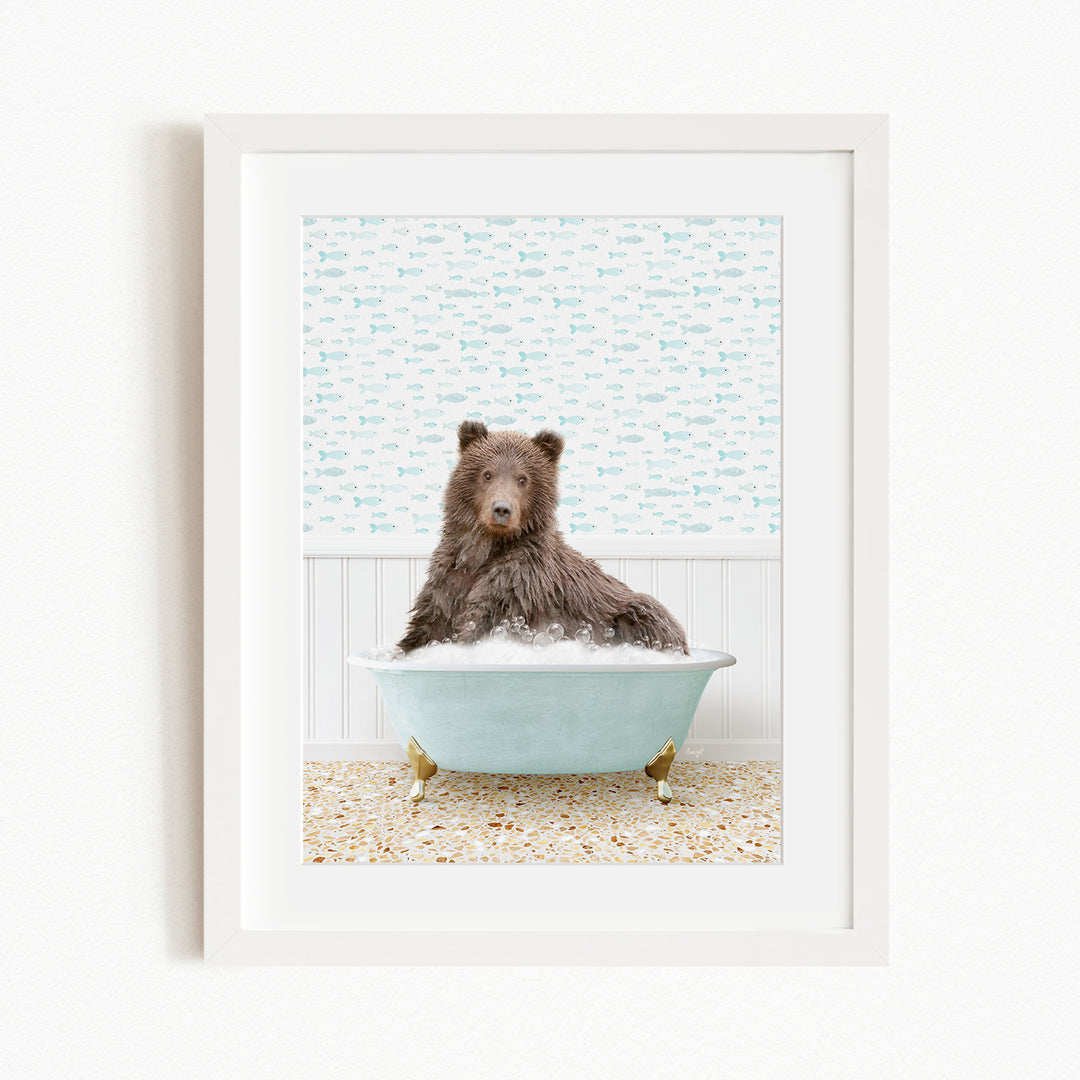 A brown bear sitting in a light blue bathtub filled with bubbles, surrounded by a patterned wall and a beige floor.