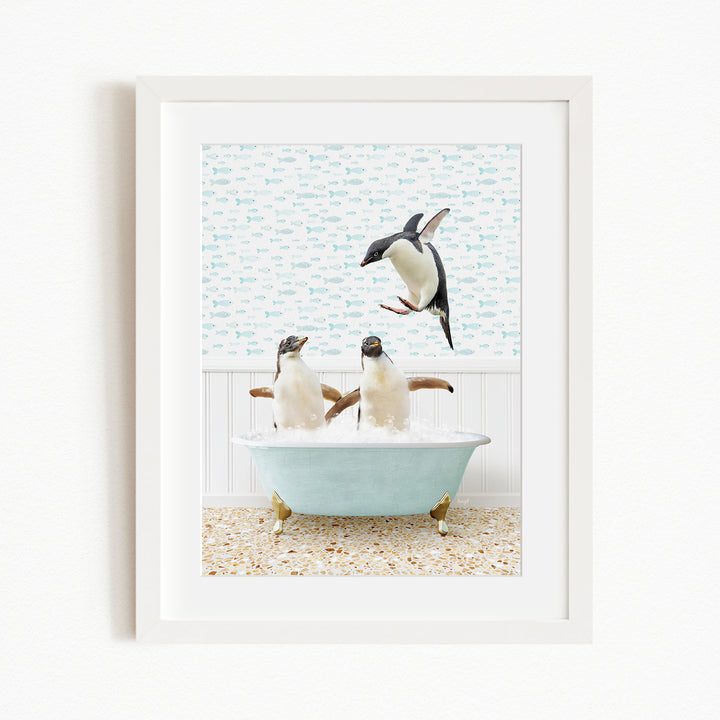 A framed image depicting two penguins sitting in a bathtub filled with bubbles, with one penguin flying towards the other.