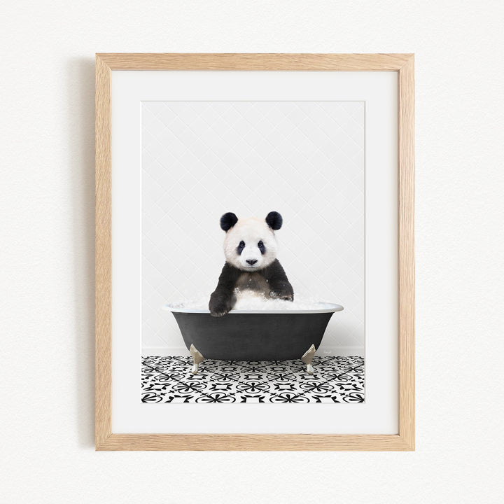 A panda bear sitting in a bathtub, surrounded by a black and white patterned tile floor.