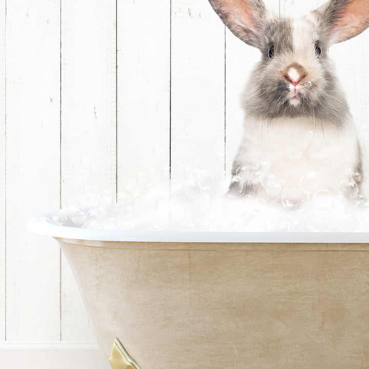 a rabbit is sitting in a bathtub with bubbles