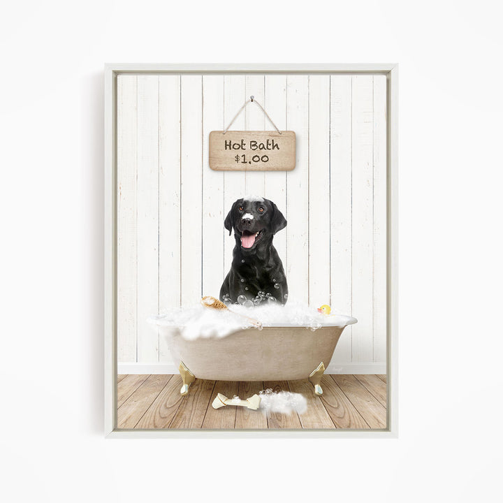 A black dog sitting in a white bathtub filled with bubbles, with a sign above the tub indicating a hot bath for $1.00.