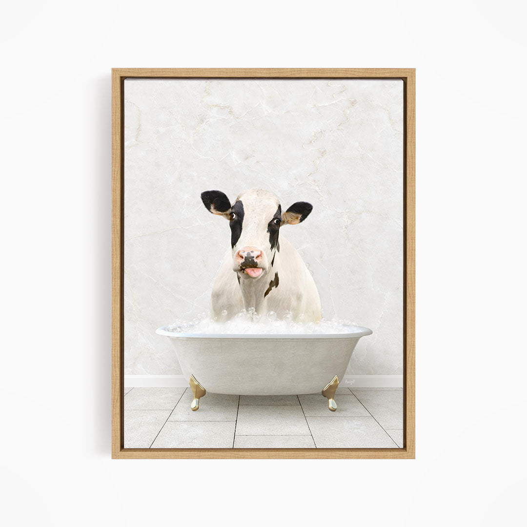 A black and white cow is sitting in a white bathtub filled with water, creating a whimsical and humorous scene.